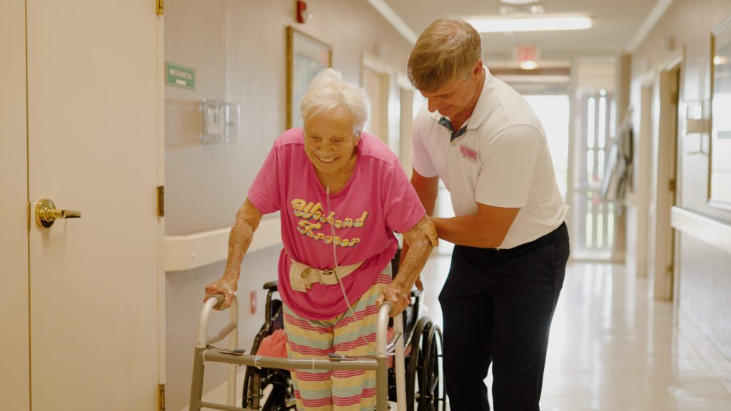 A woman smiles and is in a short term rehab facility